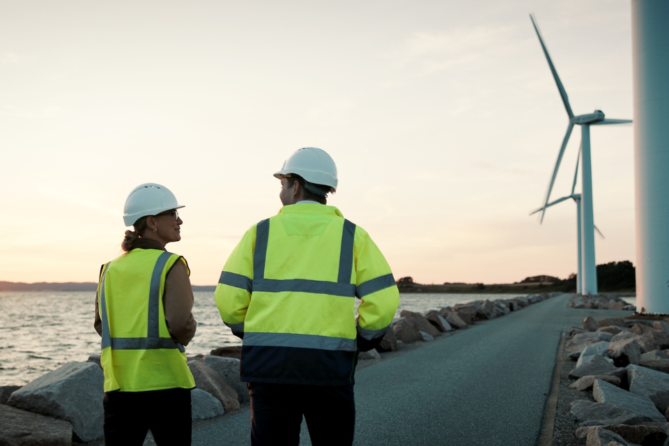 Two Colleagues Windfarm Sunset Walking.Split Block 960X640
