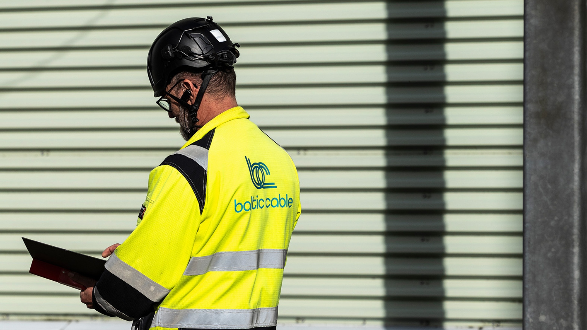 Baltic Cable Technical Expert Taking Notes.Background Image 1920X1080